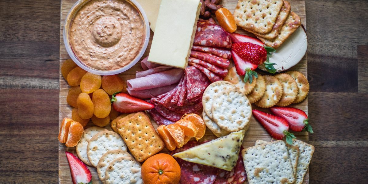 snacks with wine on a cheeseboard