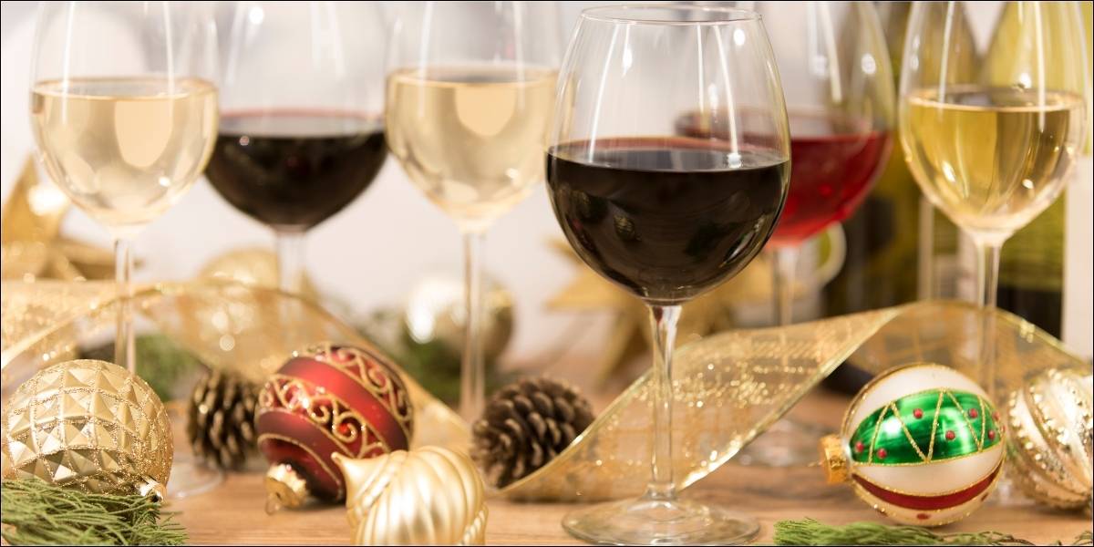 Holiday wine gifts surrounded by Christmas decorations.