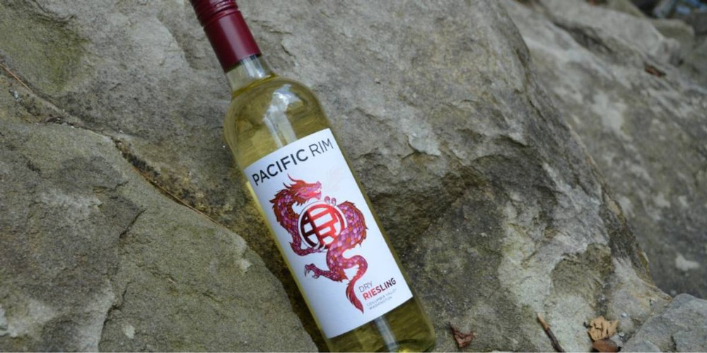 One of Pacific Rims dry white wines propped up against a rock formation.