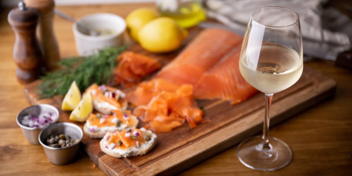 A meal being prepared, showcasing a wine pairing with salmon.