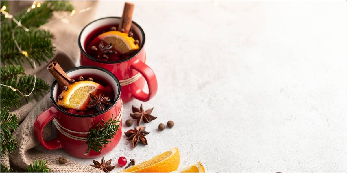 Mulled wine on display next to christmas decorations.