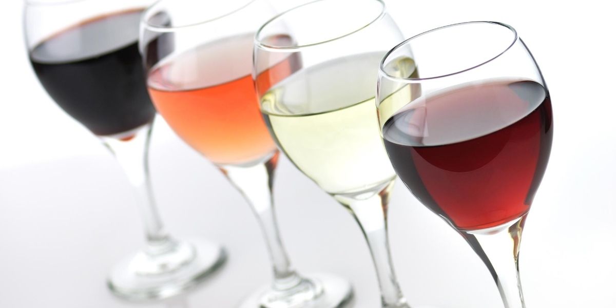 Four glasses of different types of wine